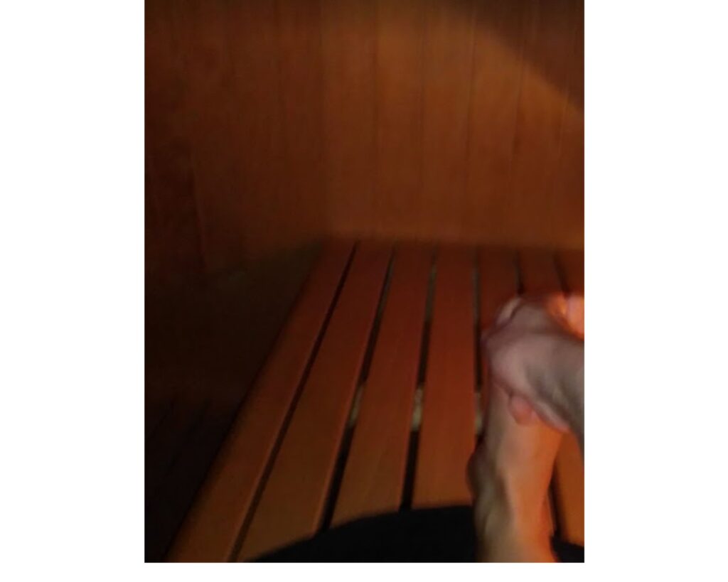 Me stretching in the sauna while trying to take a picture with one hand.